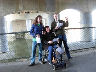 Covert Poverts perform REACTORS in the Pearson Bridge underpass to mark the 3rd anniversary of the Fukushima nuclear disaster. Kim GOldberg, Kim Clark, Darryl Knowles. (Photo by Katy McCuish)
