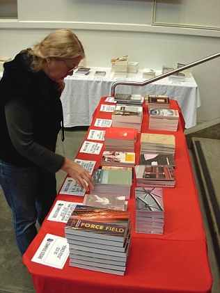 Heidi Greco explores the Seattle U book table at the Small Press Fair. Seattle U Campus Store did a phenomenal job of ordering books of all the Festival poets to have them available for sale during the fest. Thank you William Cannon! (Photo © Kim Goldberg)